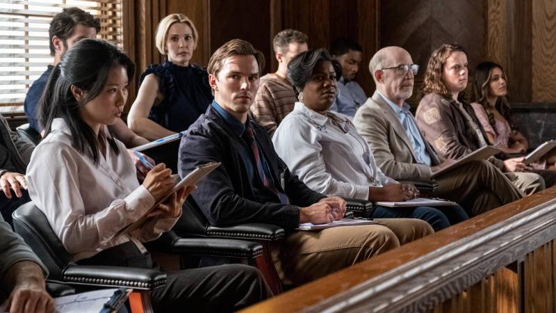 Jurors sit in two rows inside an old fashioned courtroom.