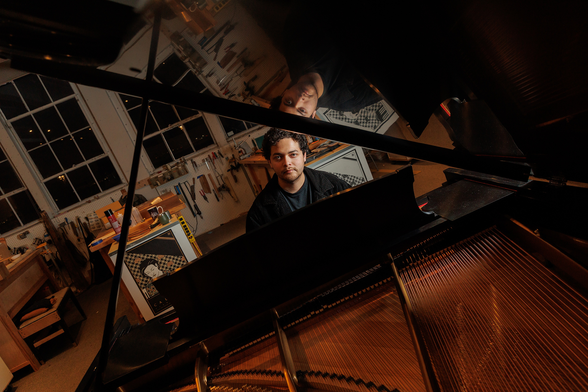 a young man plays the piano