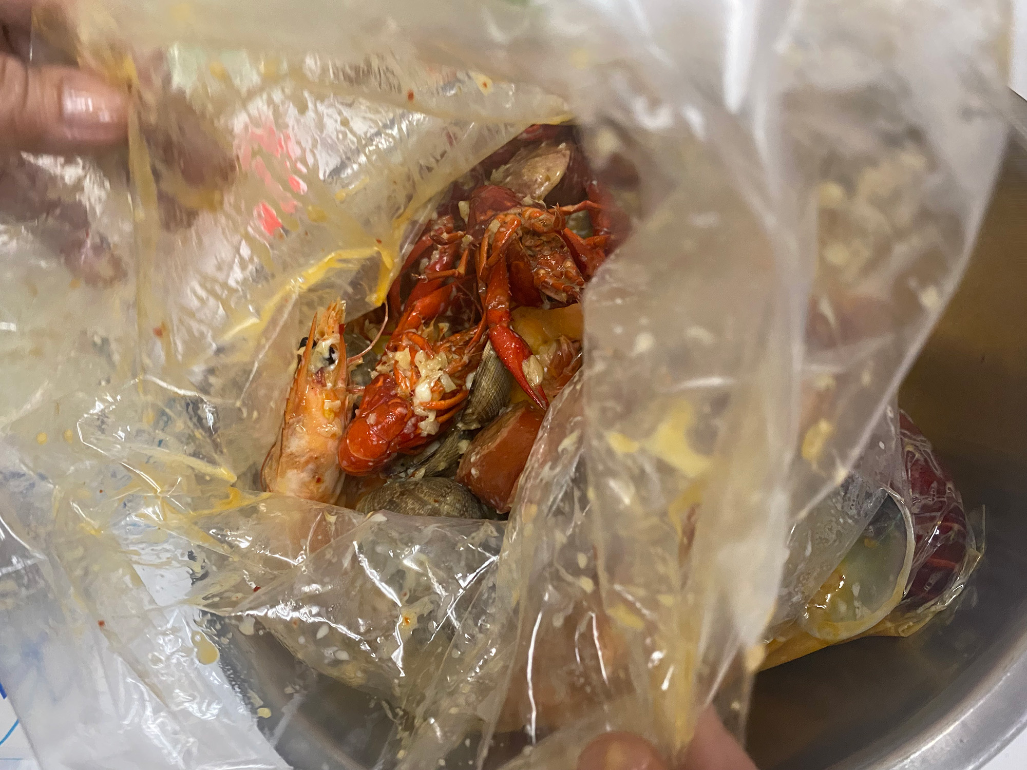 Crawfish boil in a plastic bag.