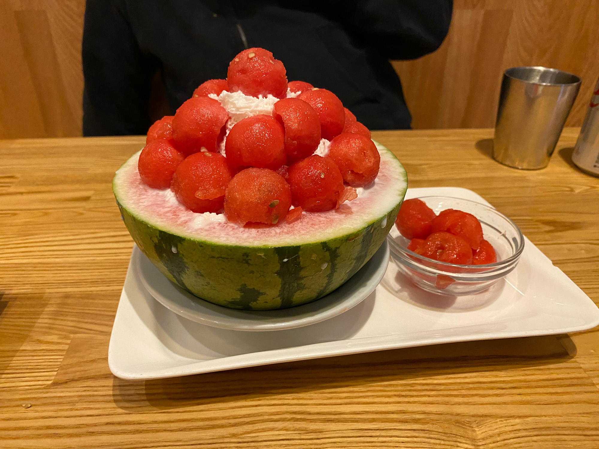 Watermelon balls and shave ice served inside the watermelon rind.