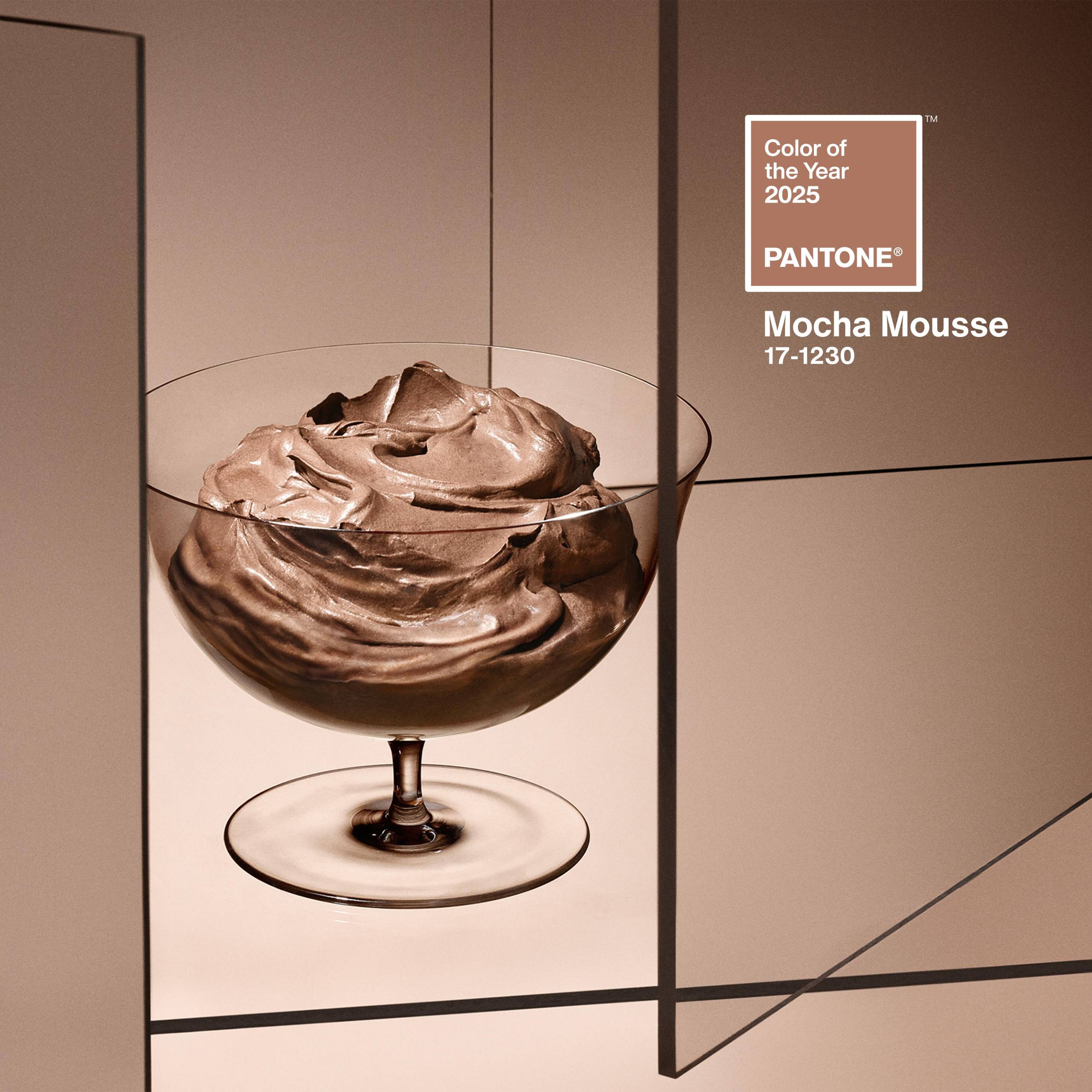 A stylized image featuring a clear cocktail glass of heavily whipped mousse.