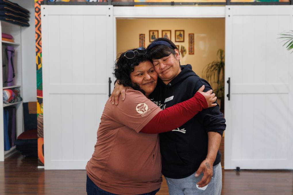 two people hug close and smile