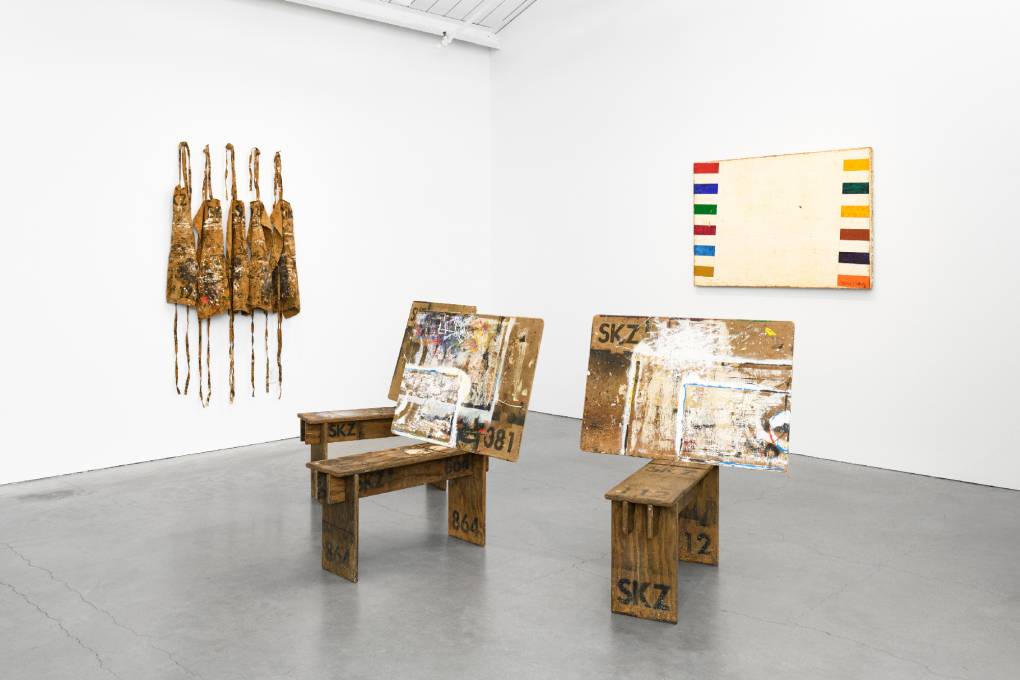 paint covered aprons, wooden stands for drawing and a modernist abstract painting