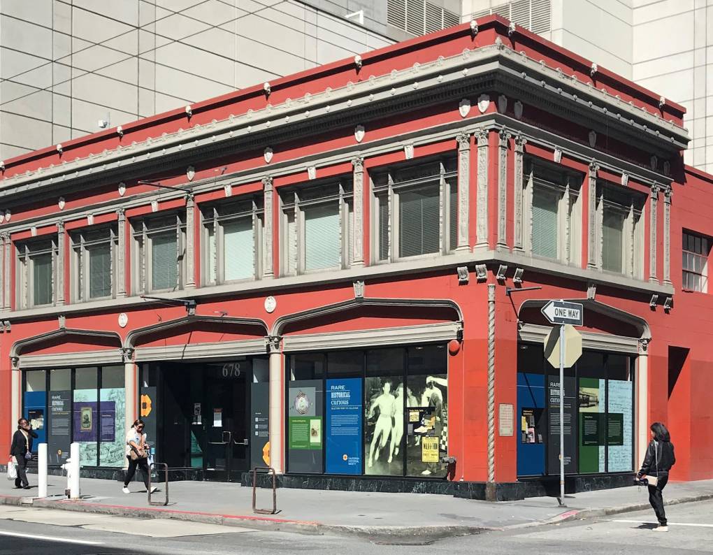 orange two-story building with window displays