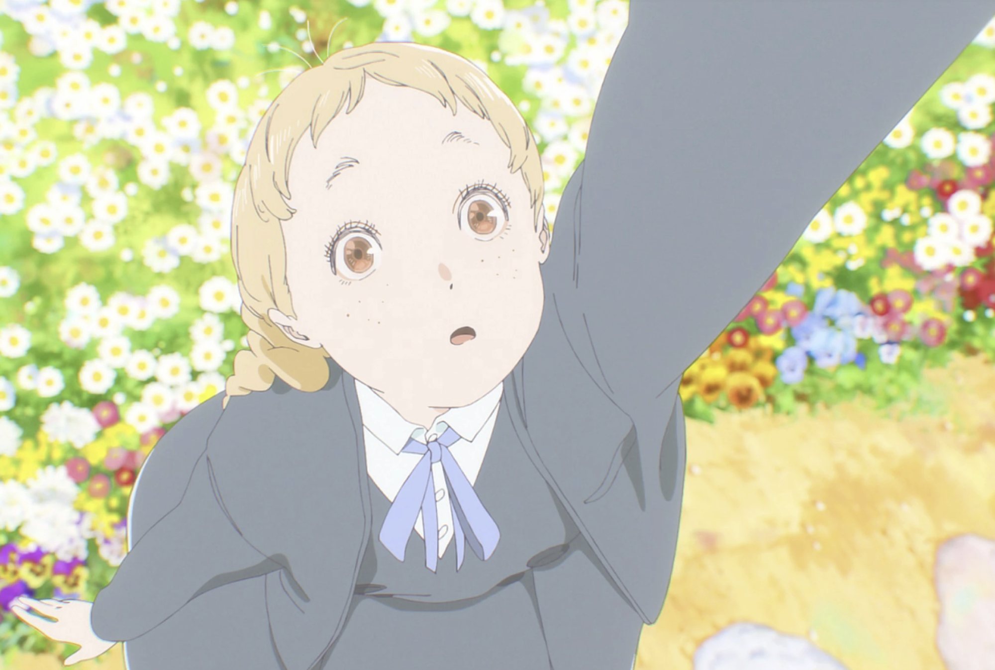 A fair-haired manga character is seen floating above a field of flowers.