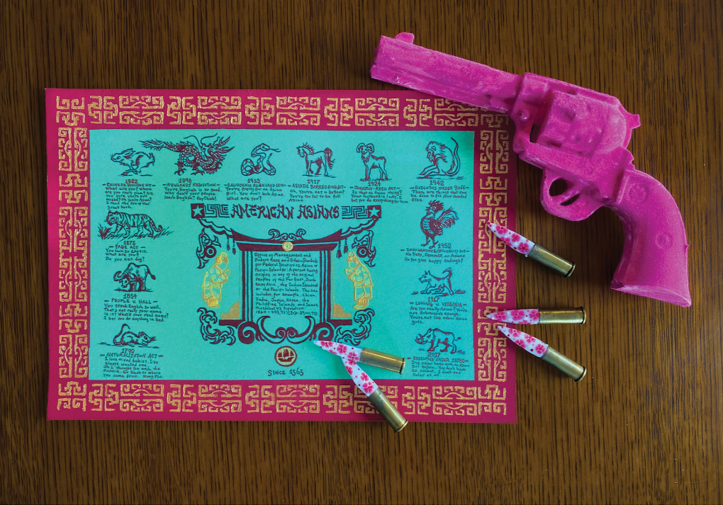 An image of a pink revolver gun, five pink-spotted bullets and a placemat.