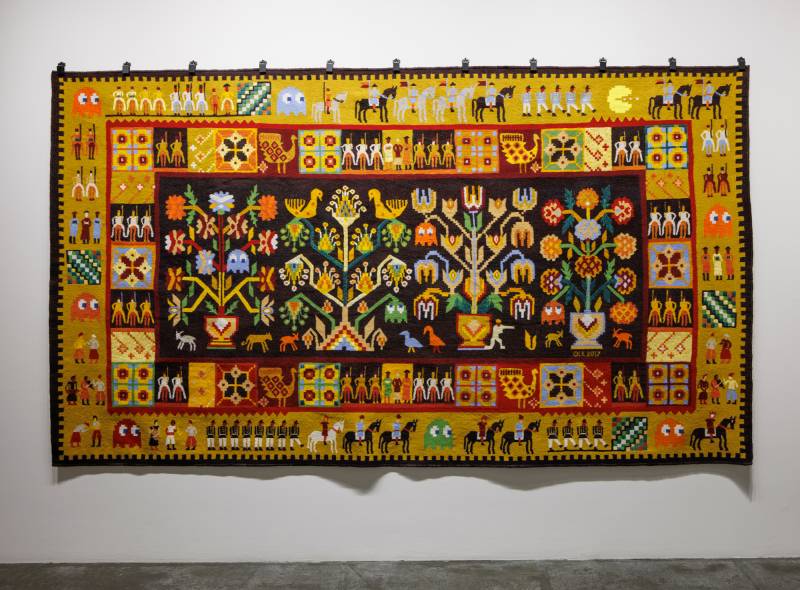 traditional-looking weaving with soldiers, plans and pac-man game characters