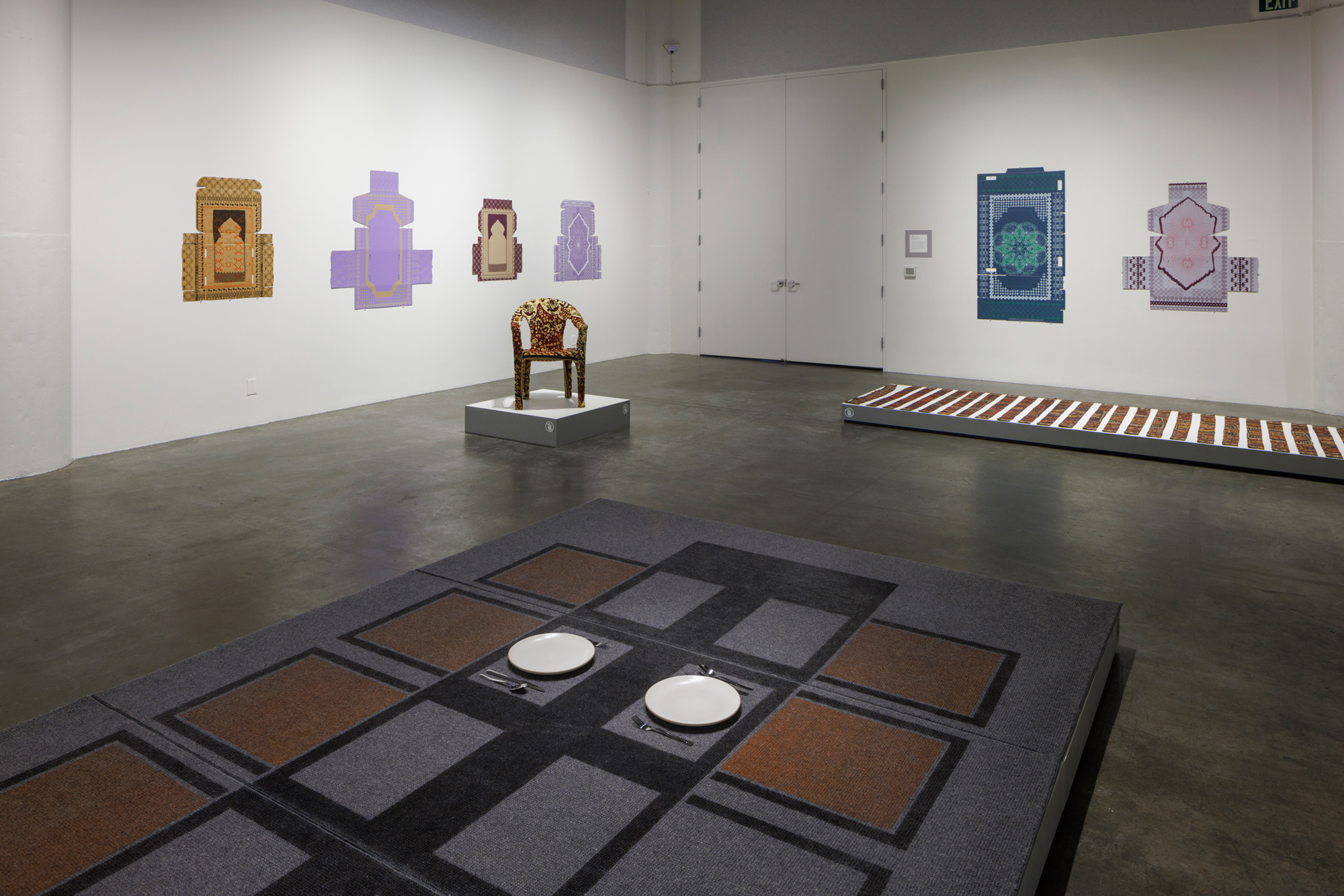 textile-inspired artwork in white wall gallery space