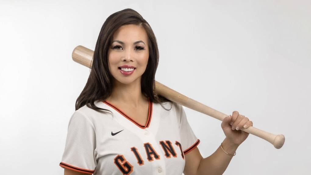 Attorney Anh Phoong poses in a Giants jersey with a baseball bat.