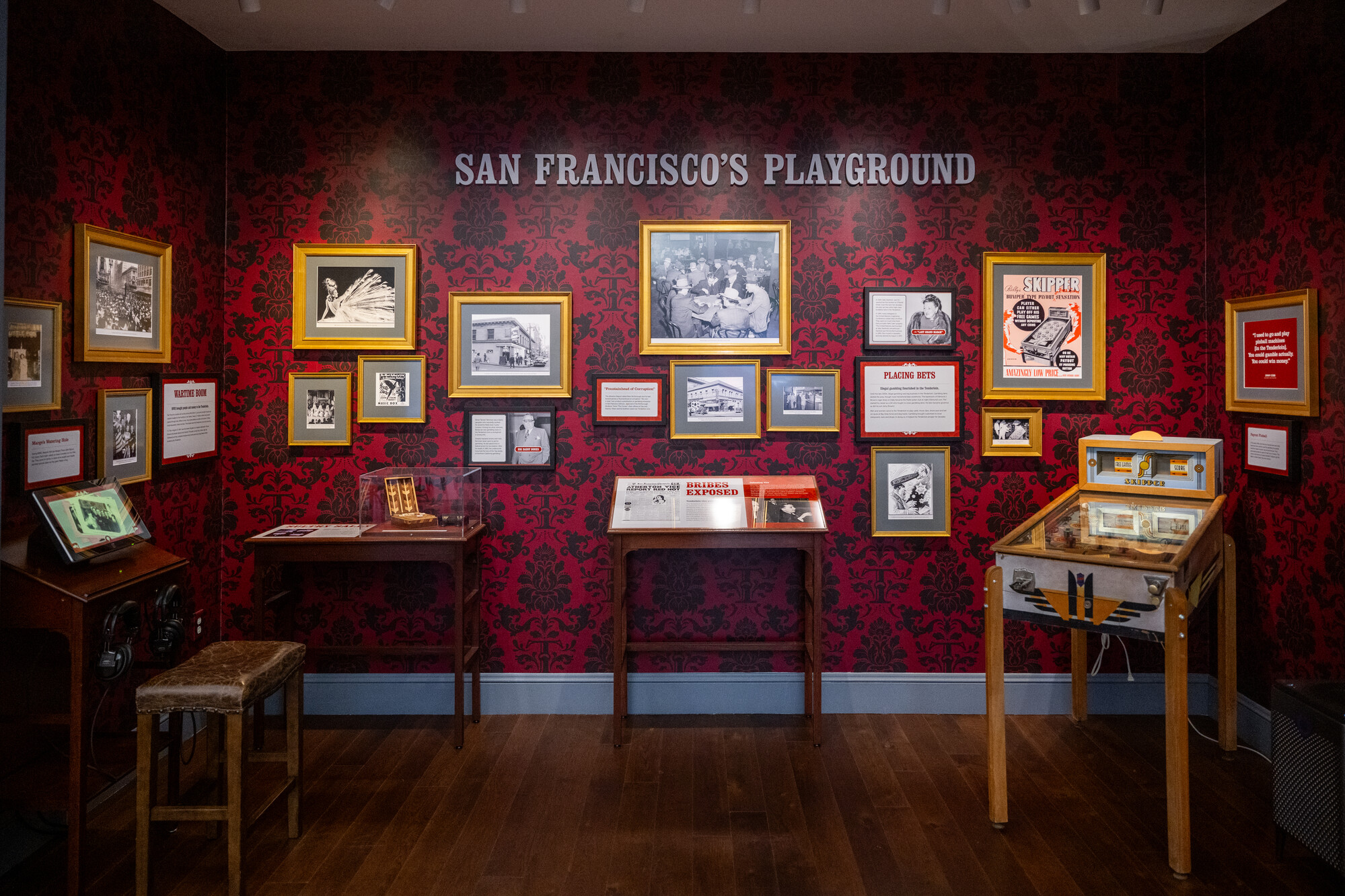 framed photos and text on red patterned wallpaper