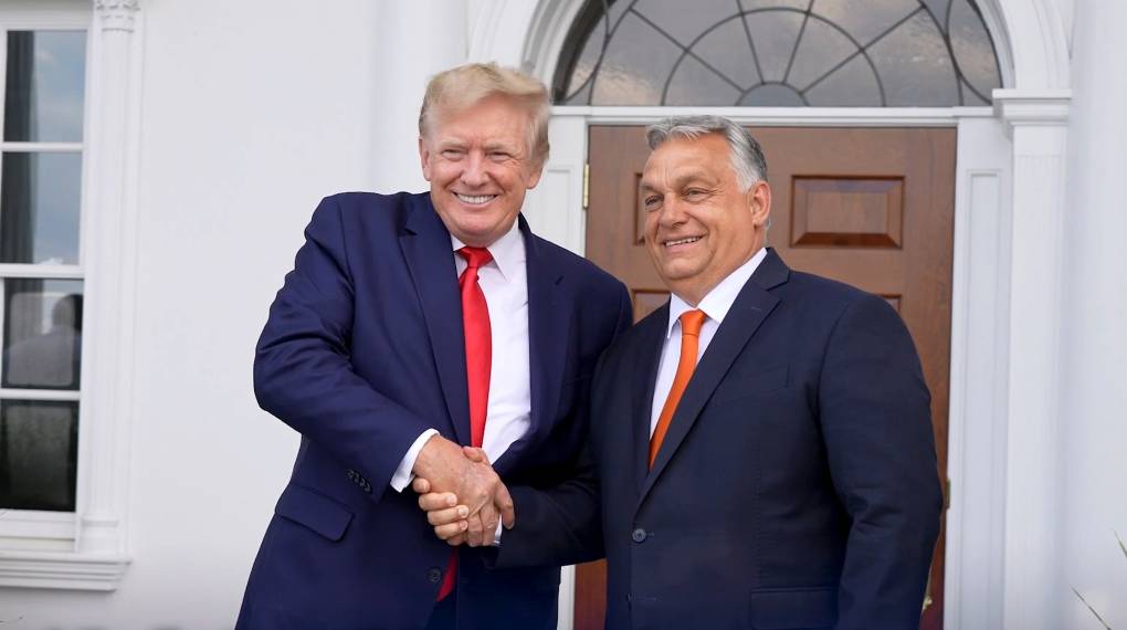 two men in suits shake hands