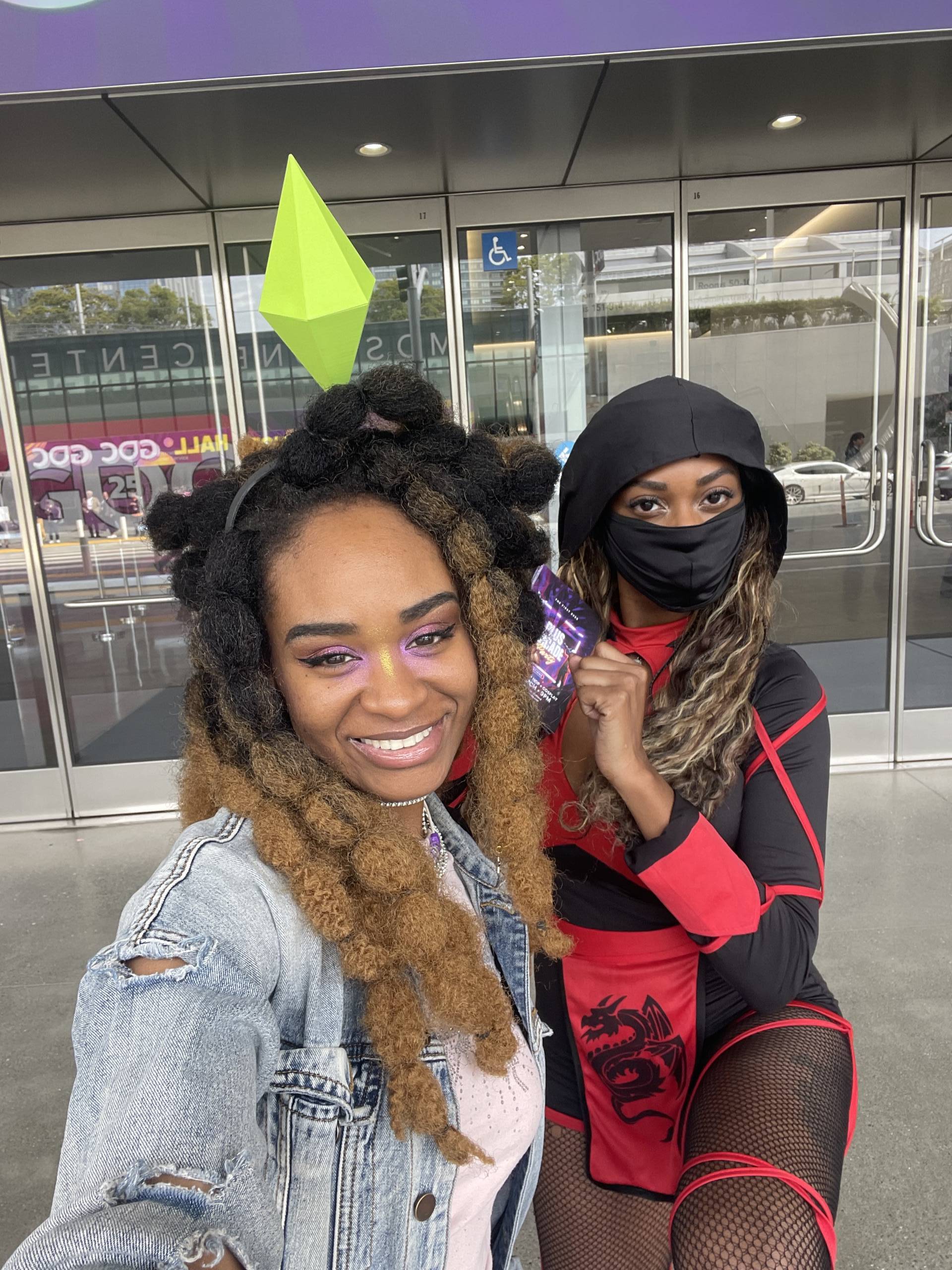 Two people dressed in costumes pose for a photo.