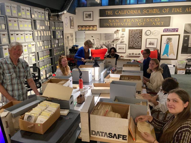 A room full of boxes and smiling people