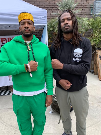 Two African-American men standing and posing for a photo.