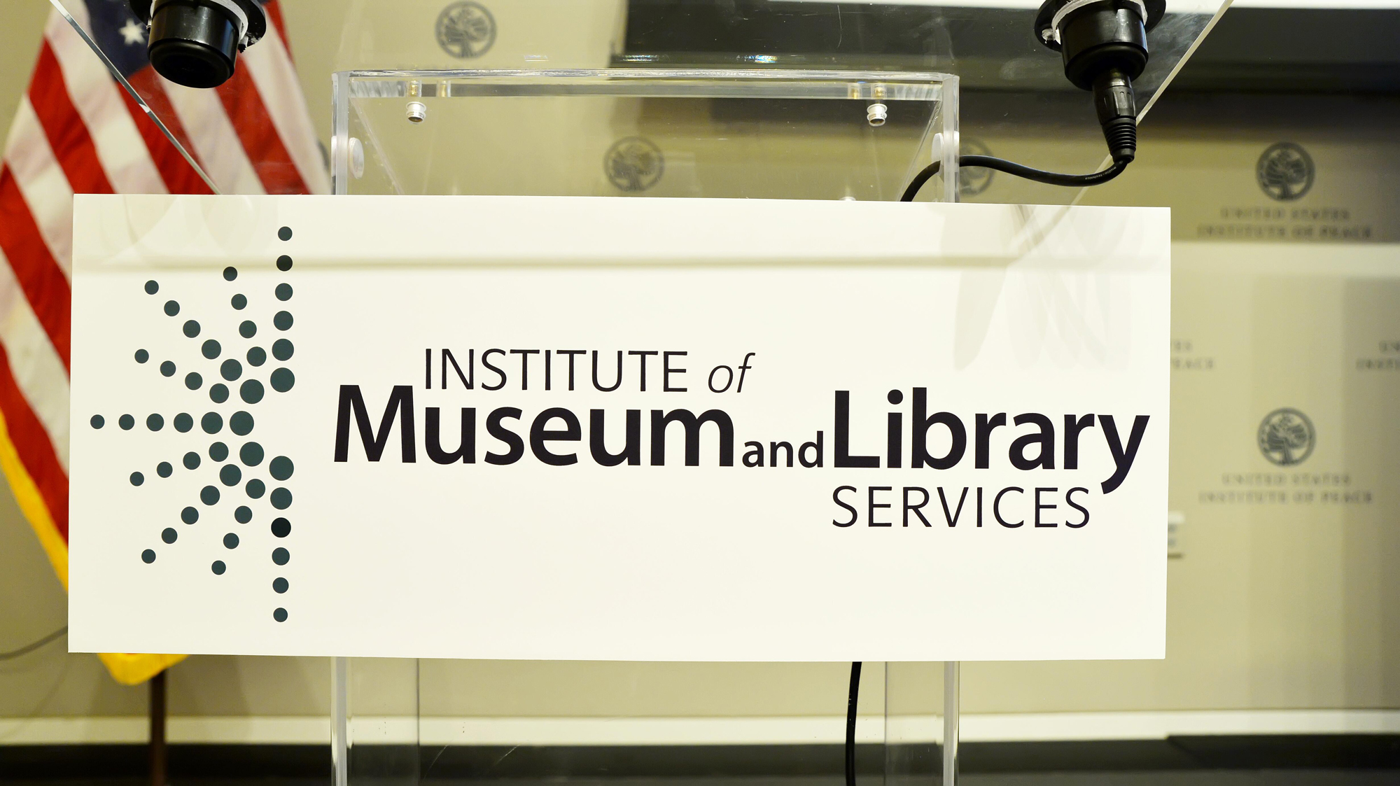 banner attached to speaker podium that reads 'Institute of Museum and Library Services'