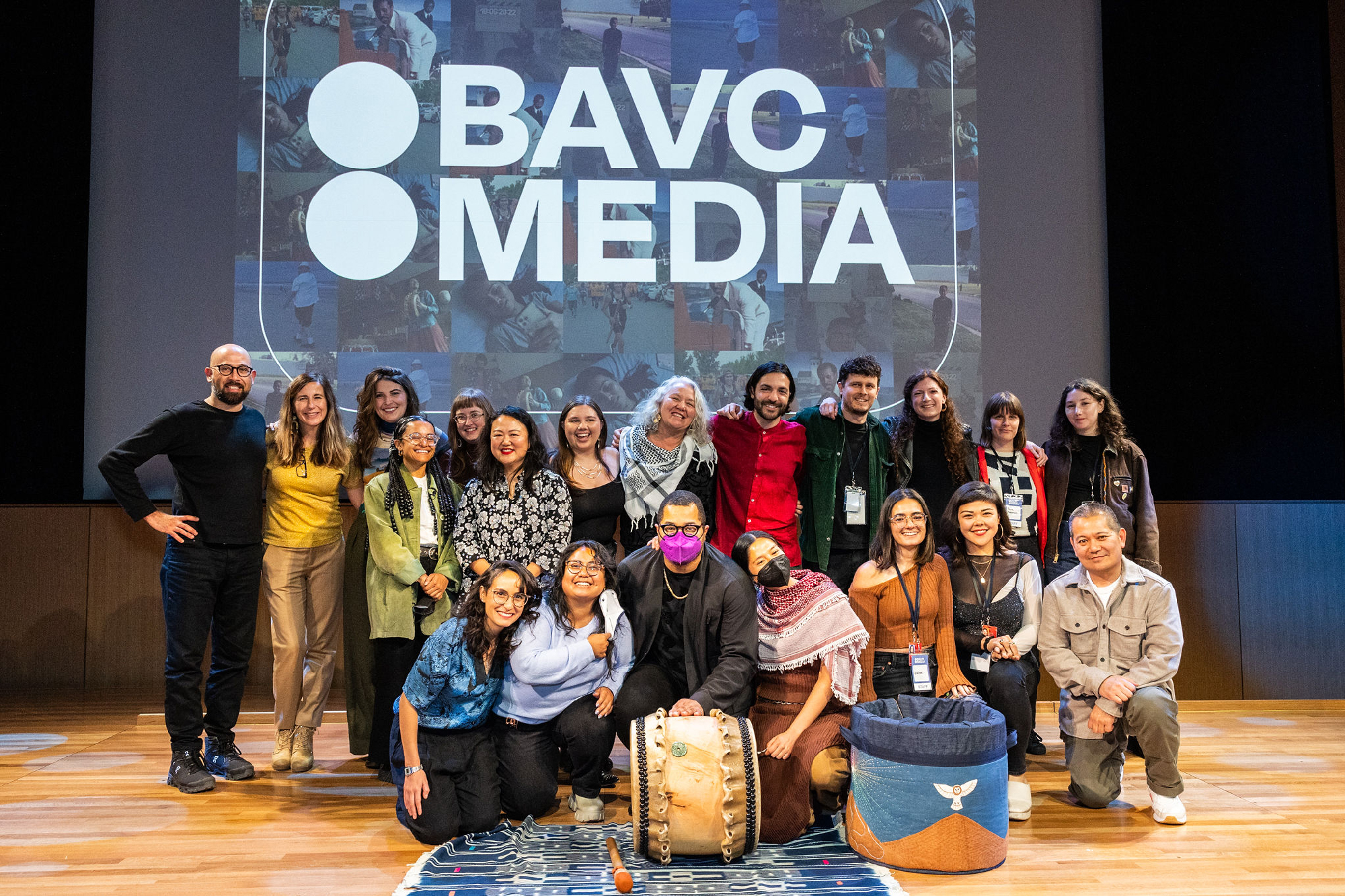 group image of smiling people on stage