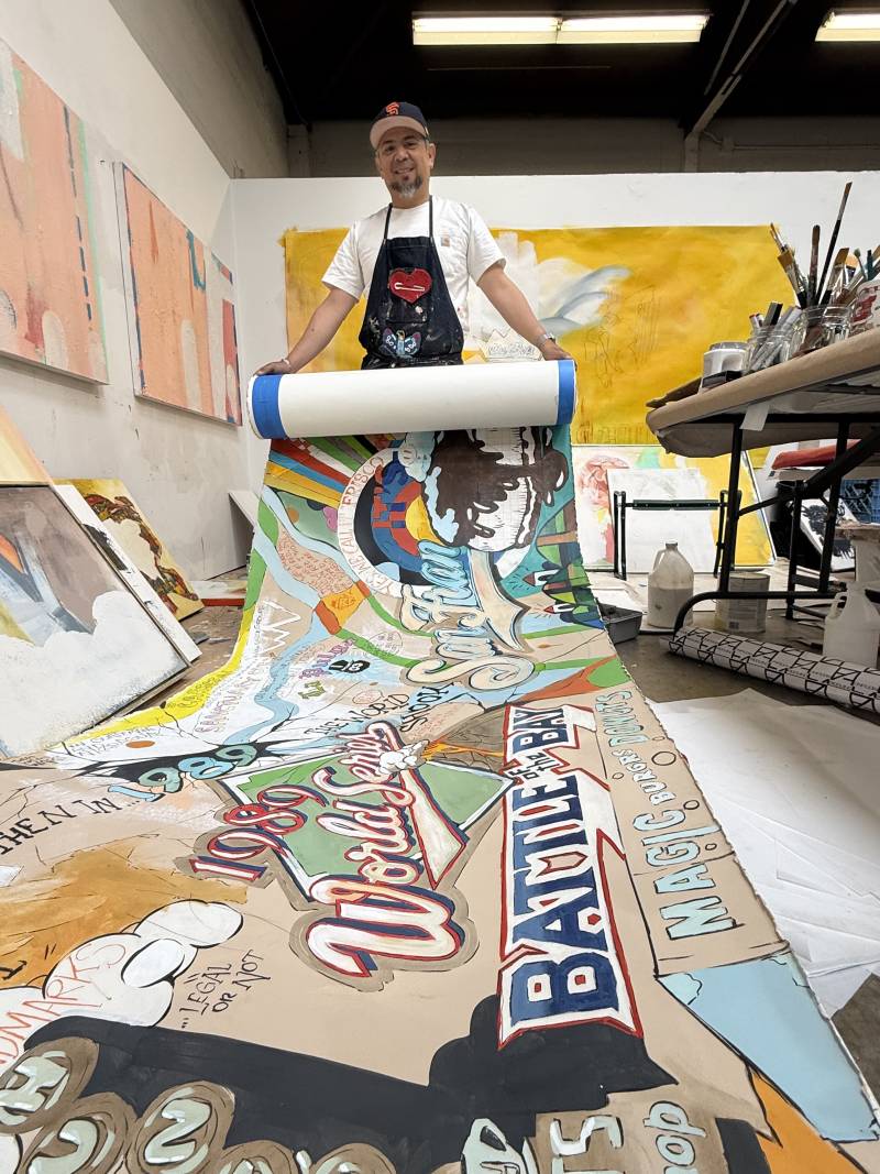 An artist rolls out a scroll full of paint and words. 
