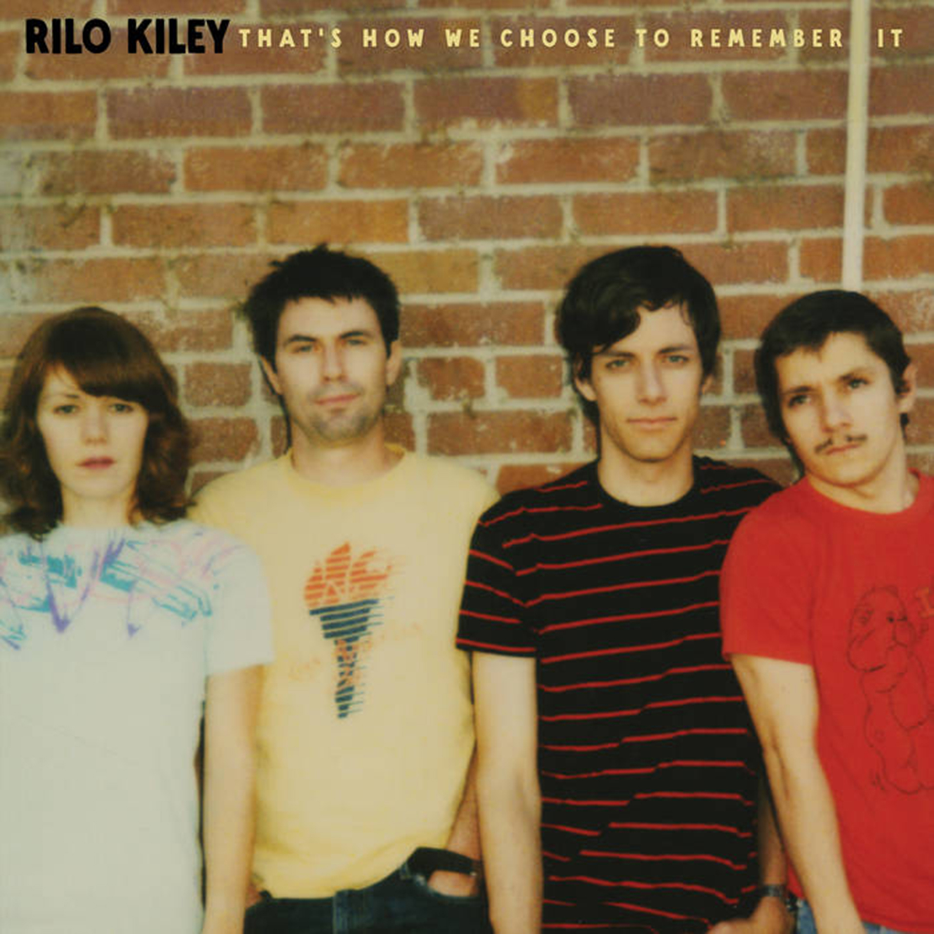 Album cover: Four band members stand in front of a brick wall in a photo from the late '90s.