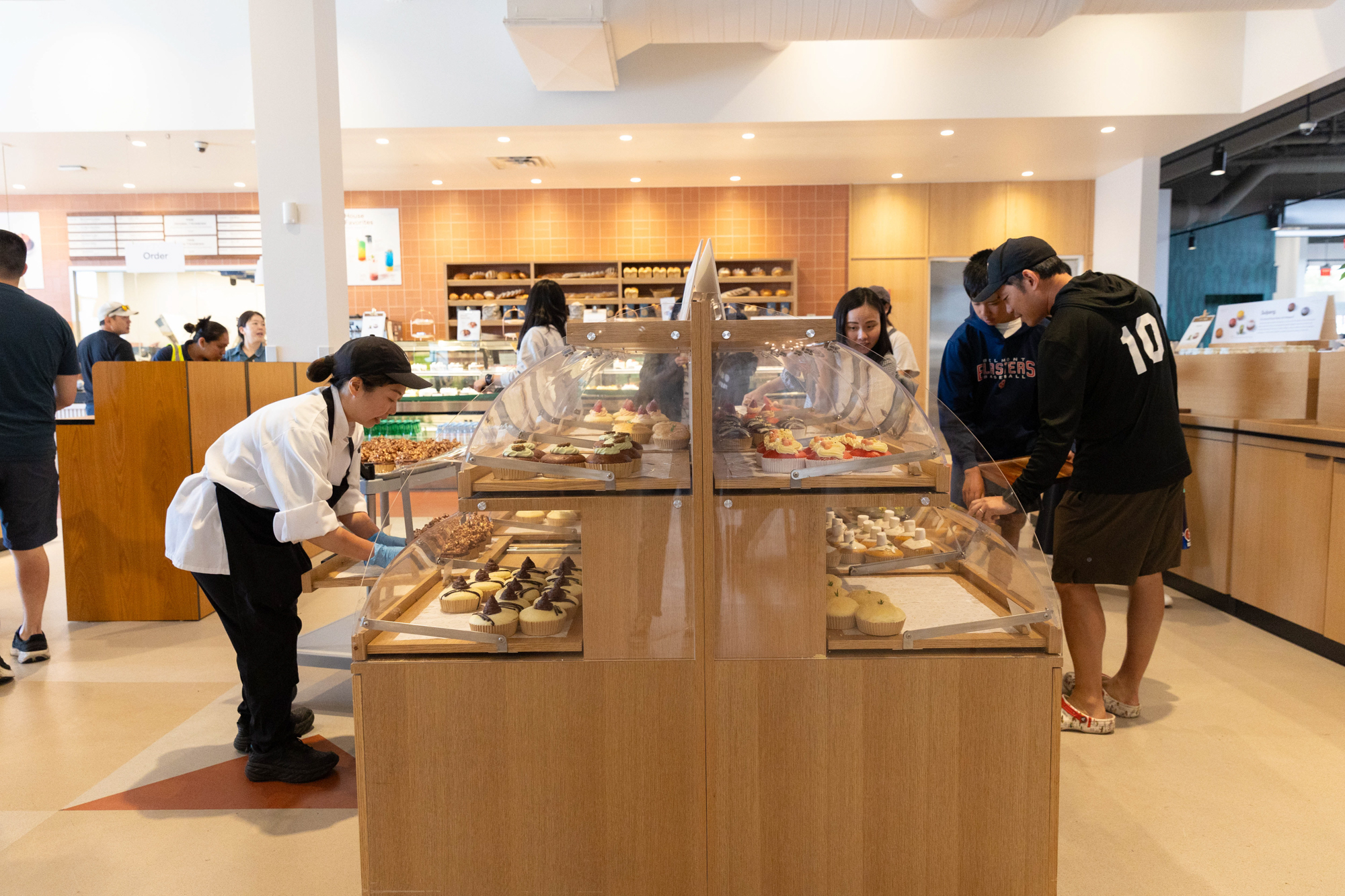 Shoppers inside an upscale Asian bakery.