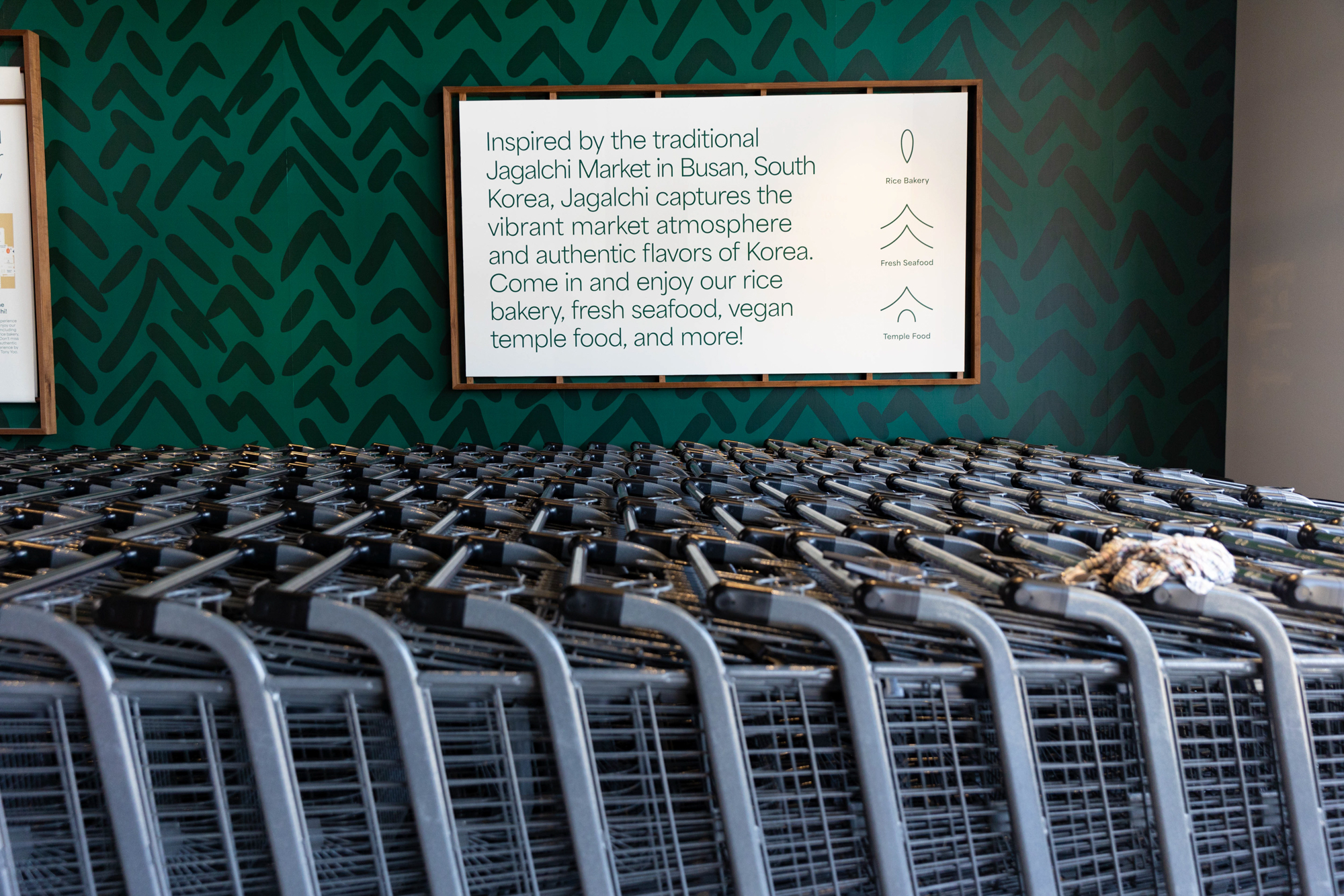 Shopping carts bunched up at the entrance to a grocery store.