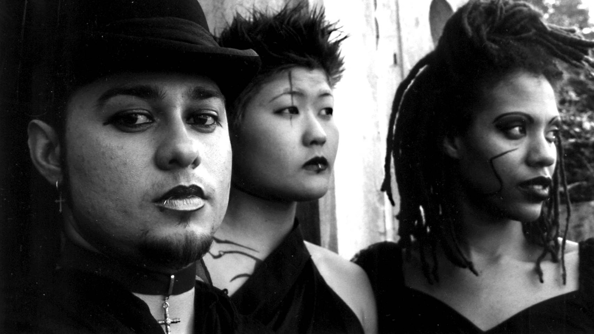 black-and-white image of three people in goth attire