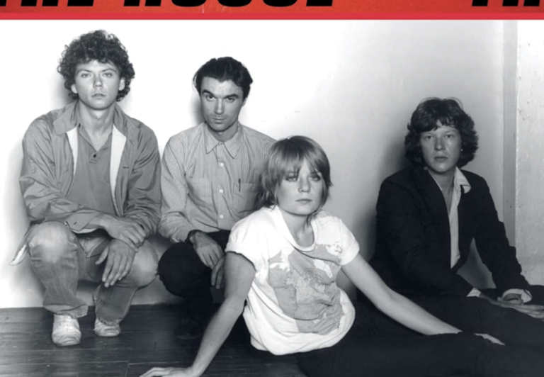 A black and white photo of three young white men and a white woman, all wearing early 1980s-era clothing.