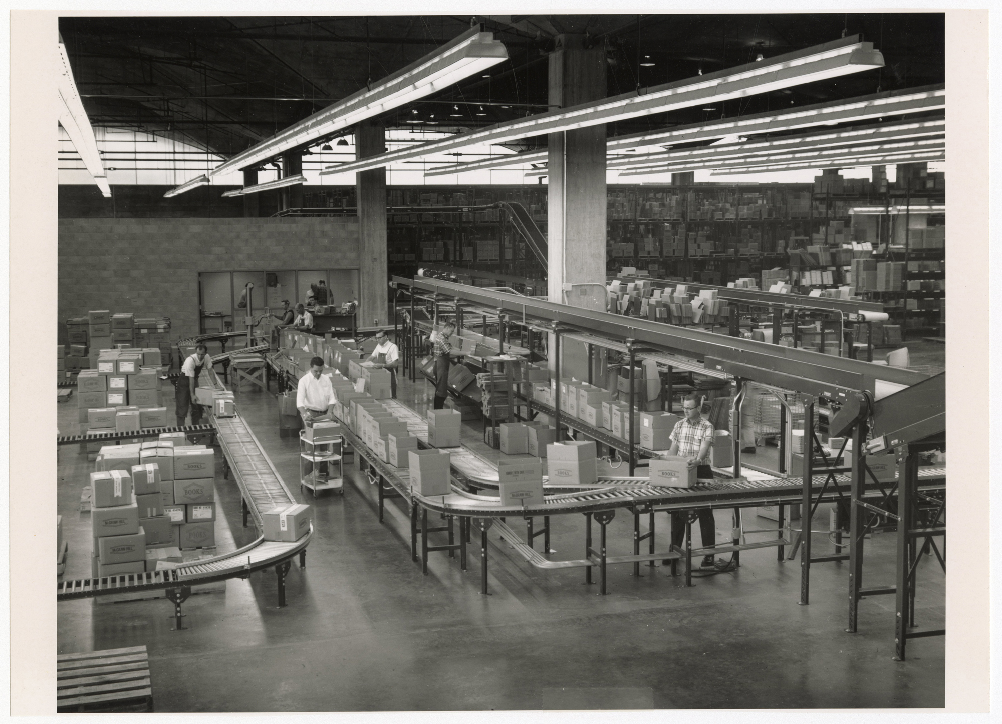 photo of boxes on conveyor belts in large factory