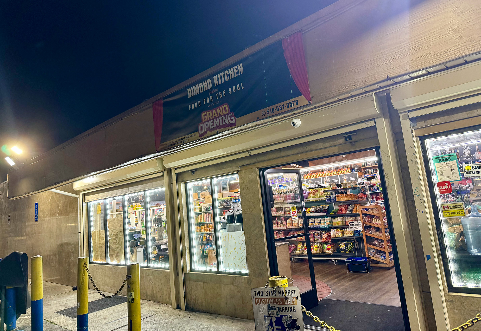 Exterior of a convenience store. The banner above reads, "Dimond Kitchen: Food for the Soul. Grand Opening."