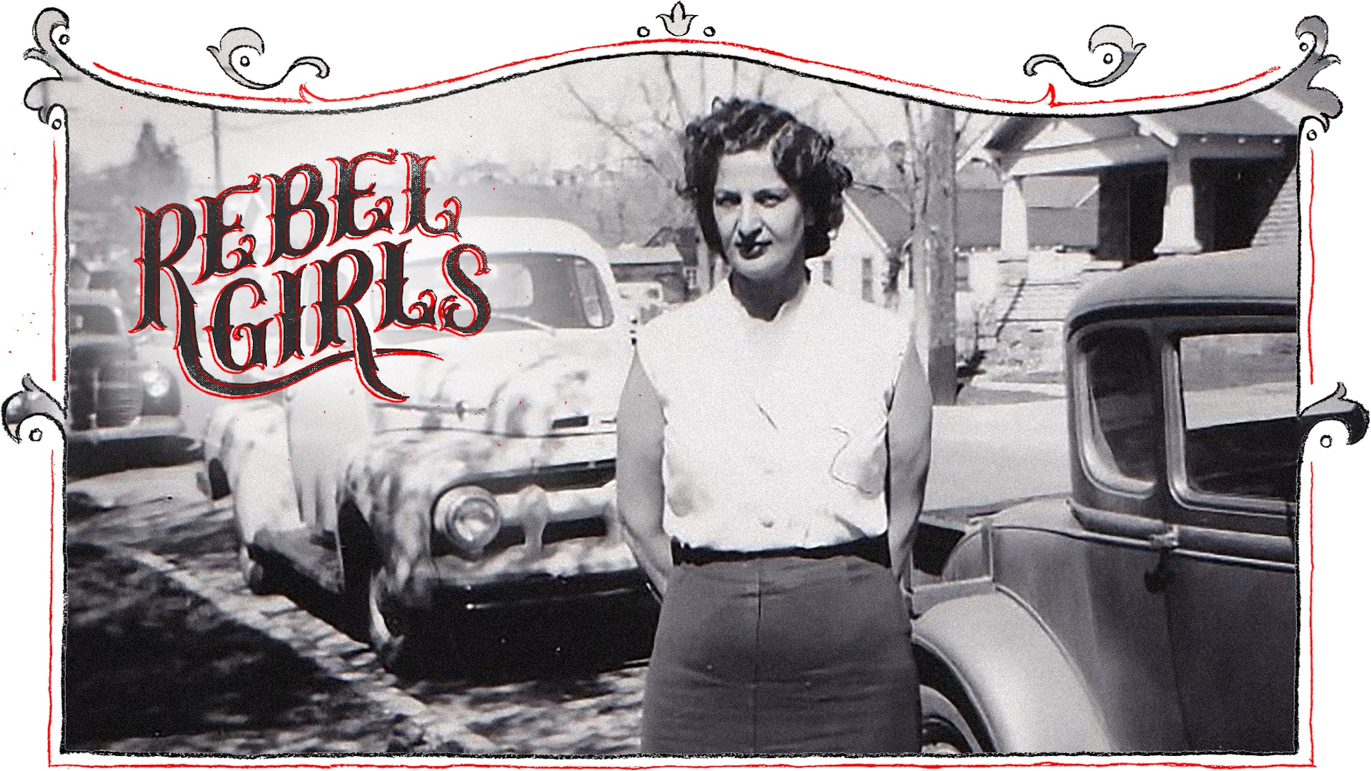 A black and white image of a 1940s-era woman standing near trucks and cars.