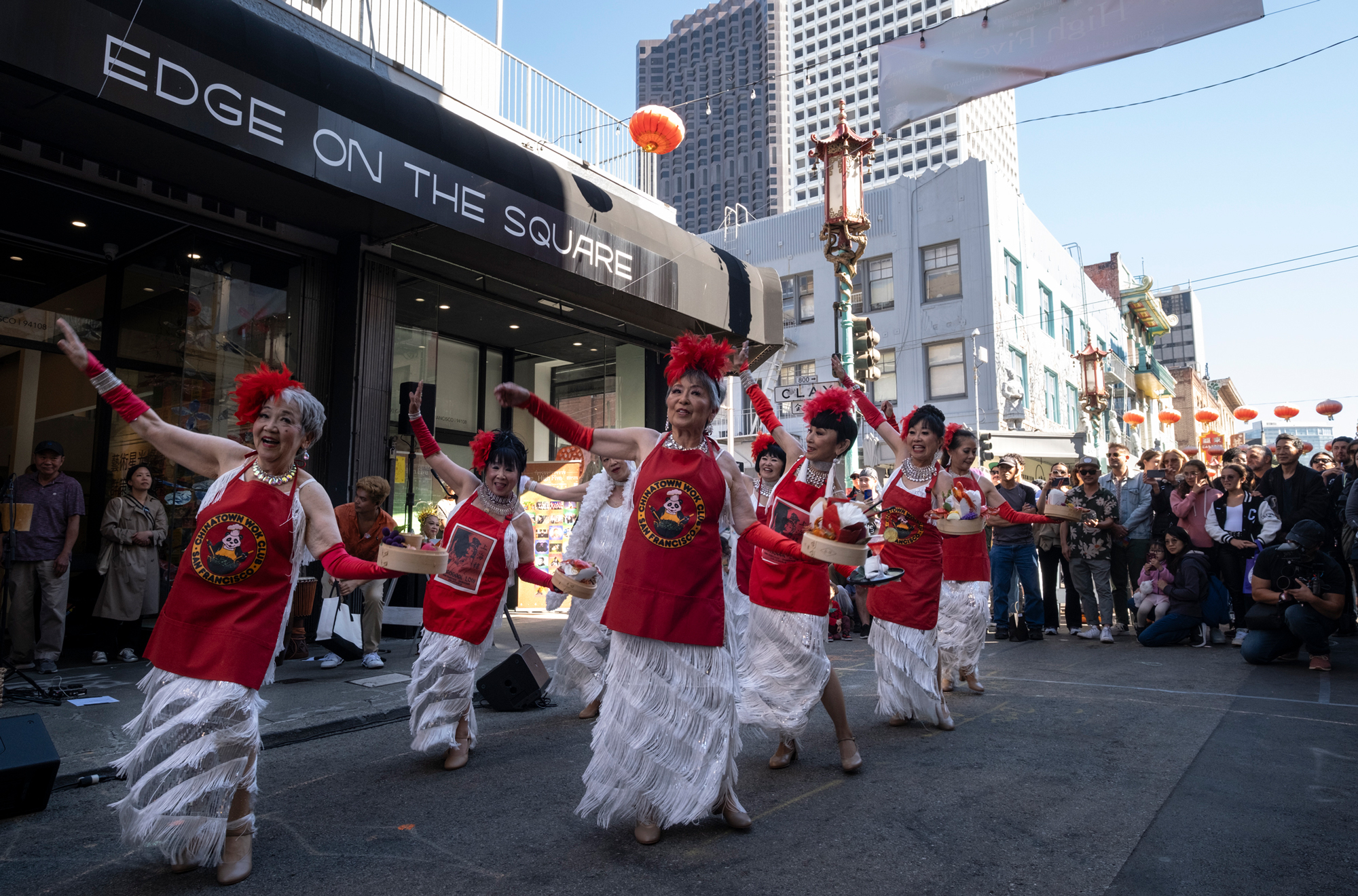 older women in matching outfits perform in street