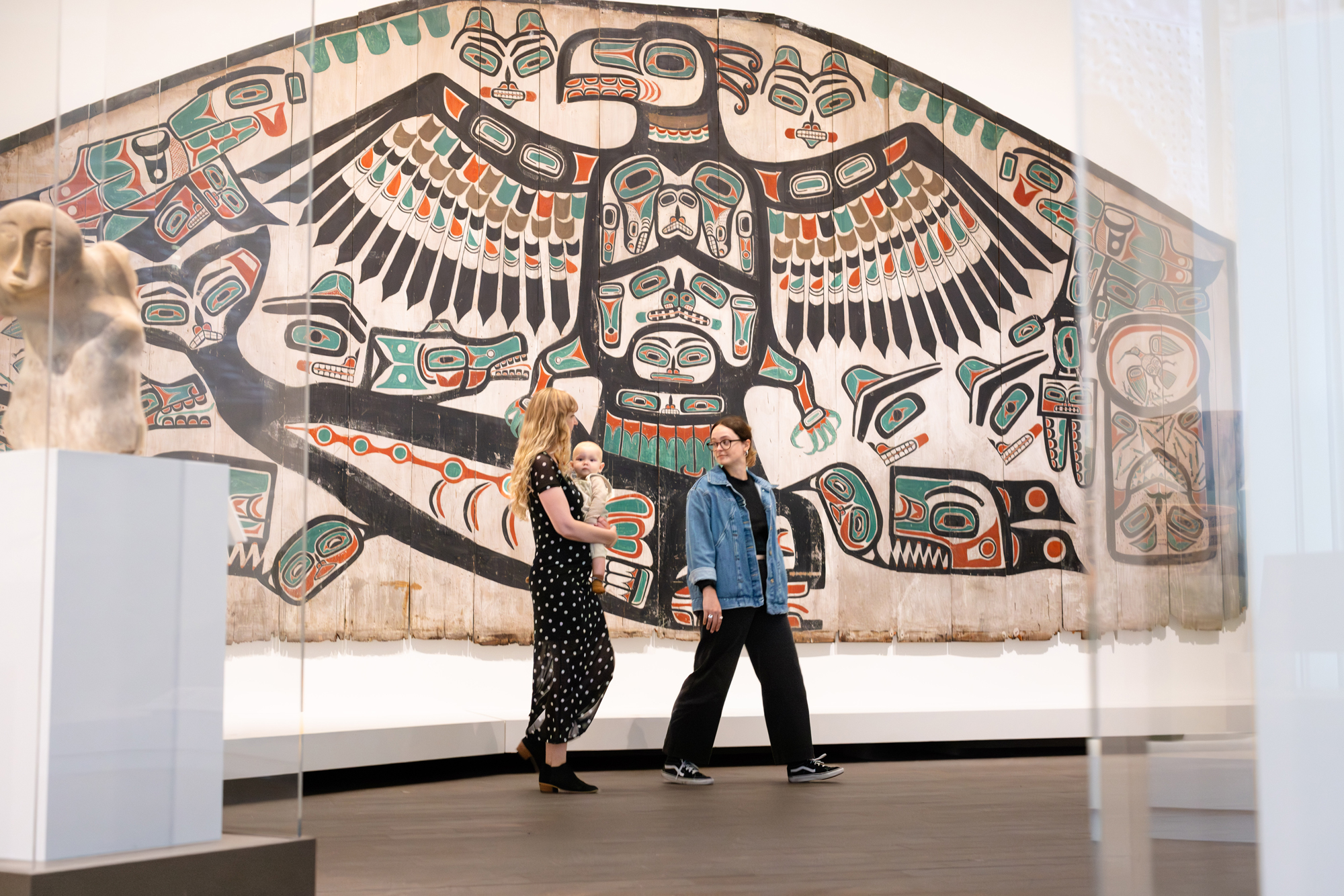 large-scale painted wooden screen on wall in gallery