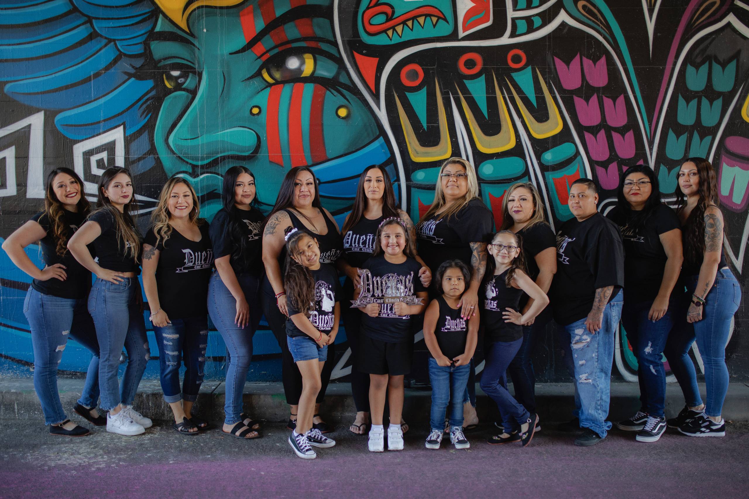 An intergenerational group of Latina women pose for a photo.