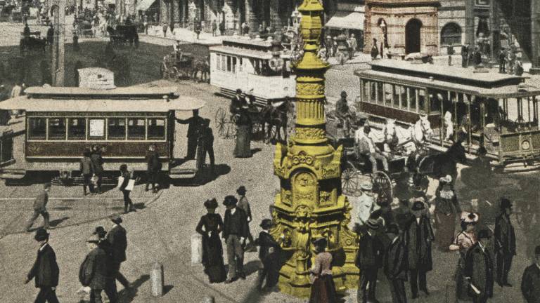 hand-tinted image of gold fountain on busy street