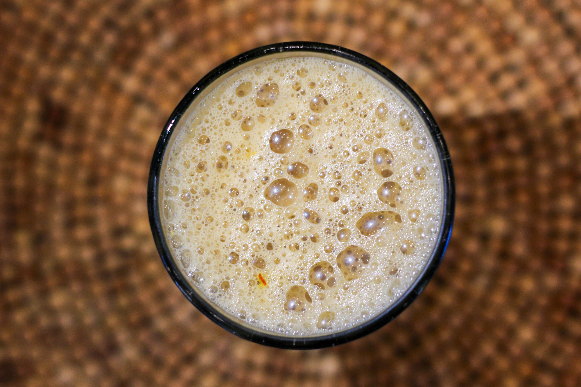 Overhead view of a cup of very frothy chai.