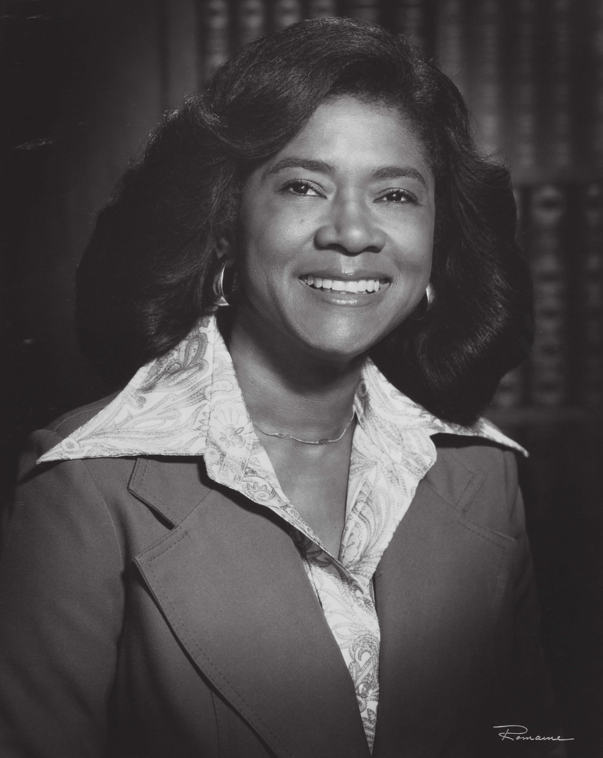 A young Black woman smiles at the camera in a headshot from the '70s.