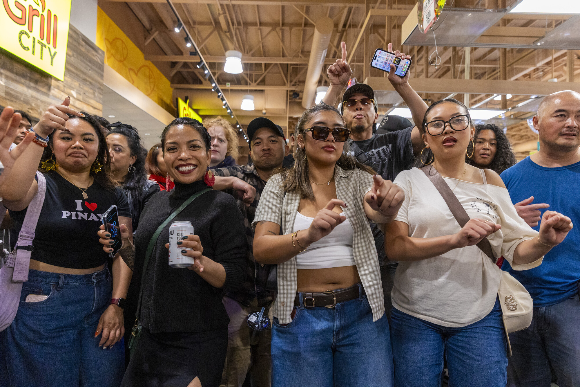 Crowd of Filipinos dancing inside a supermarket.