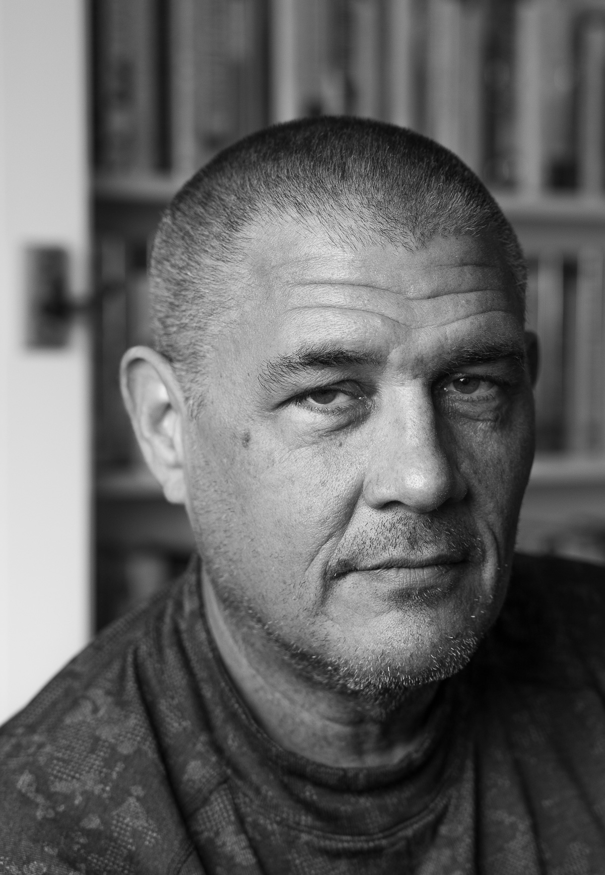 person with close-cropped hair, mustache and beard