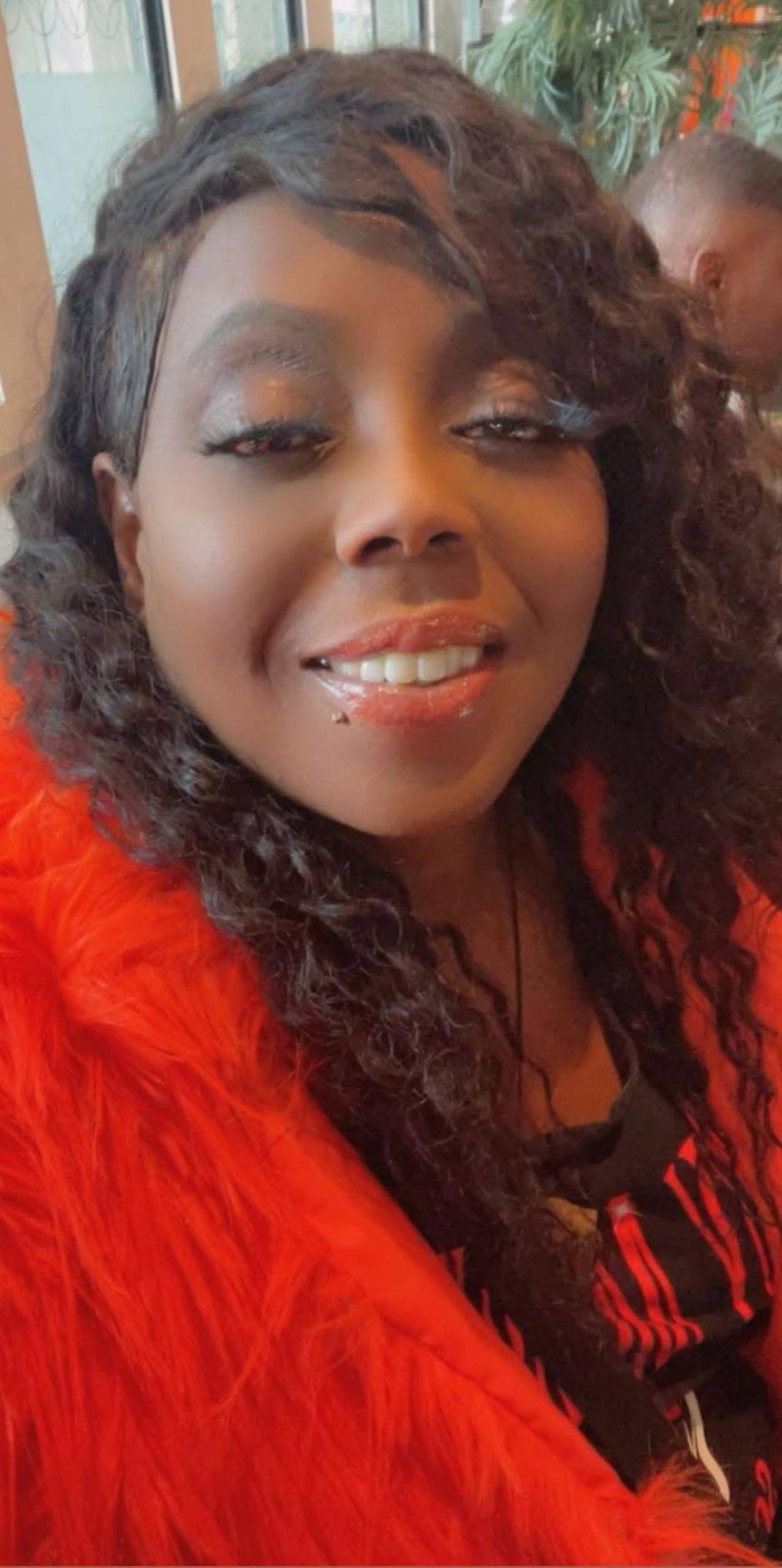 A woman in red poses for a photo.