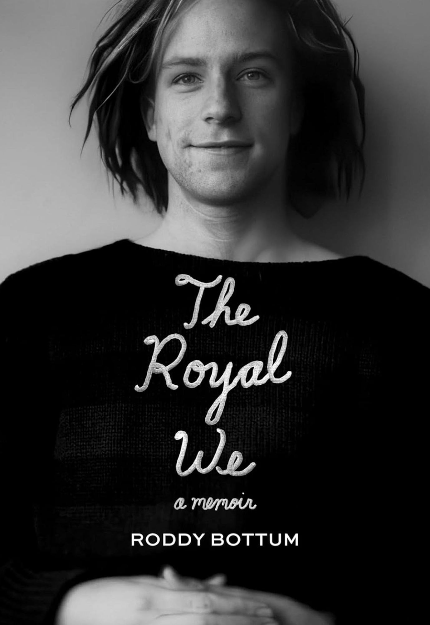 A book cover featuring a black and white image of a young white man with chin-length dreadlocks standing against a blank wall and smiling sweetly. He is wearing a black sweater. 