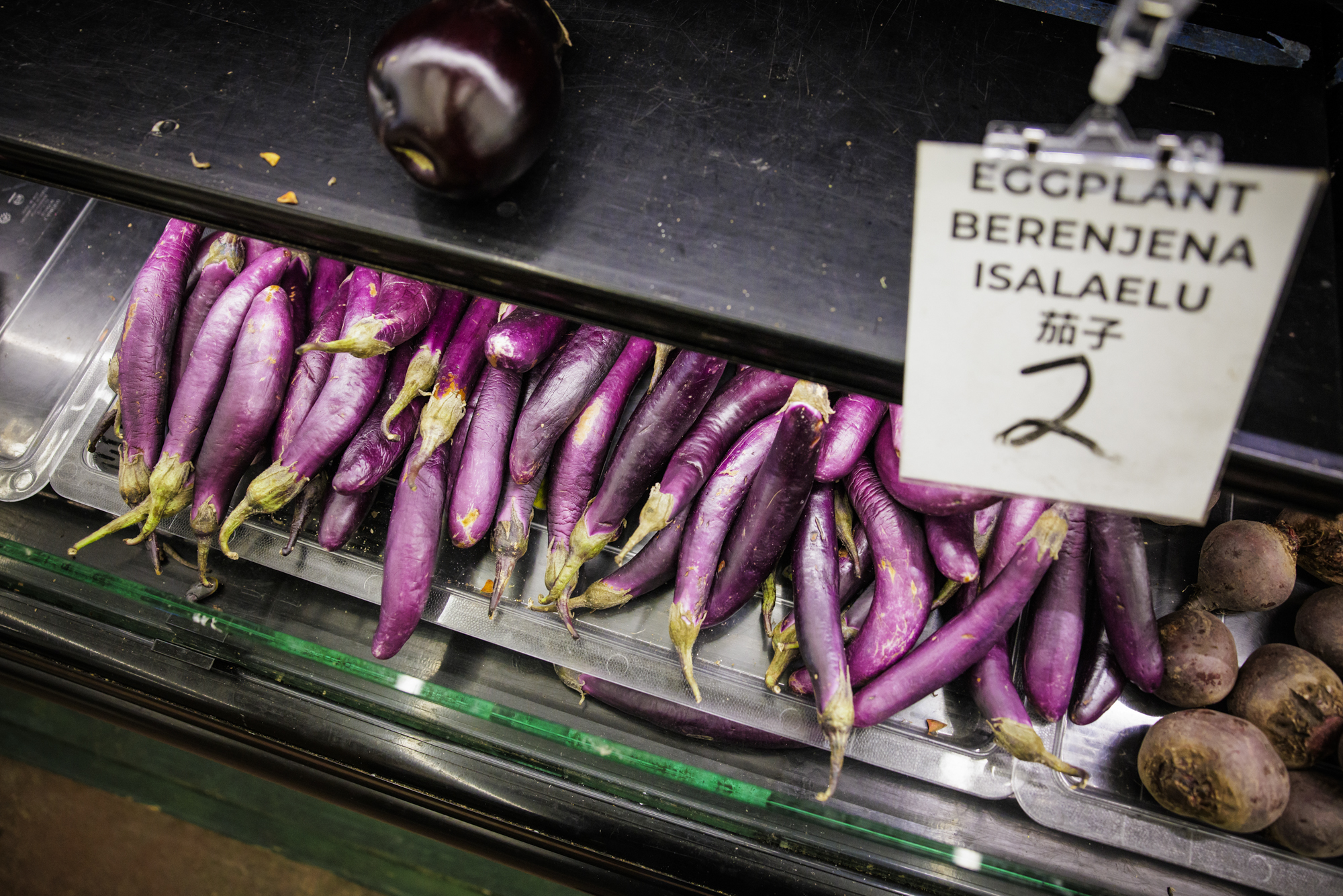 A display of eggplants in a produce market.