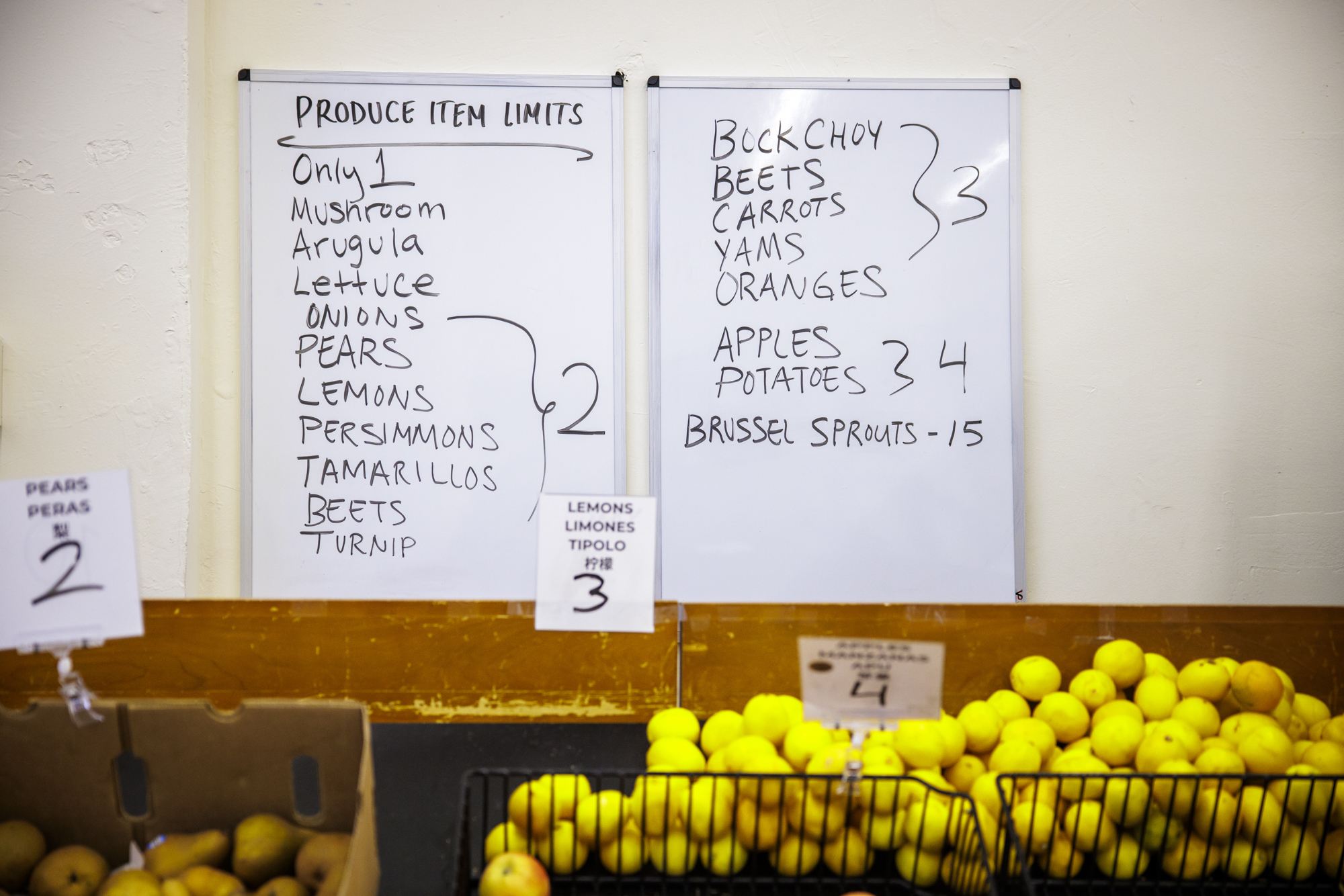A handwritten sign enumerates how many pieces of produce shoppers are allowed to take.