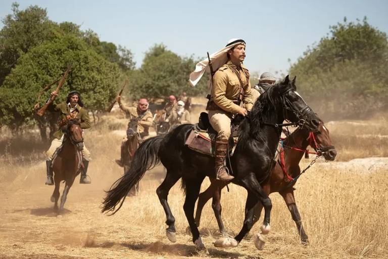 A film still shows a Palestinian man riding on horseback.