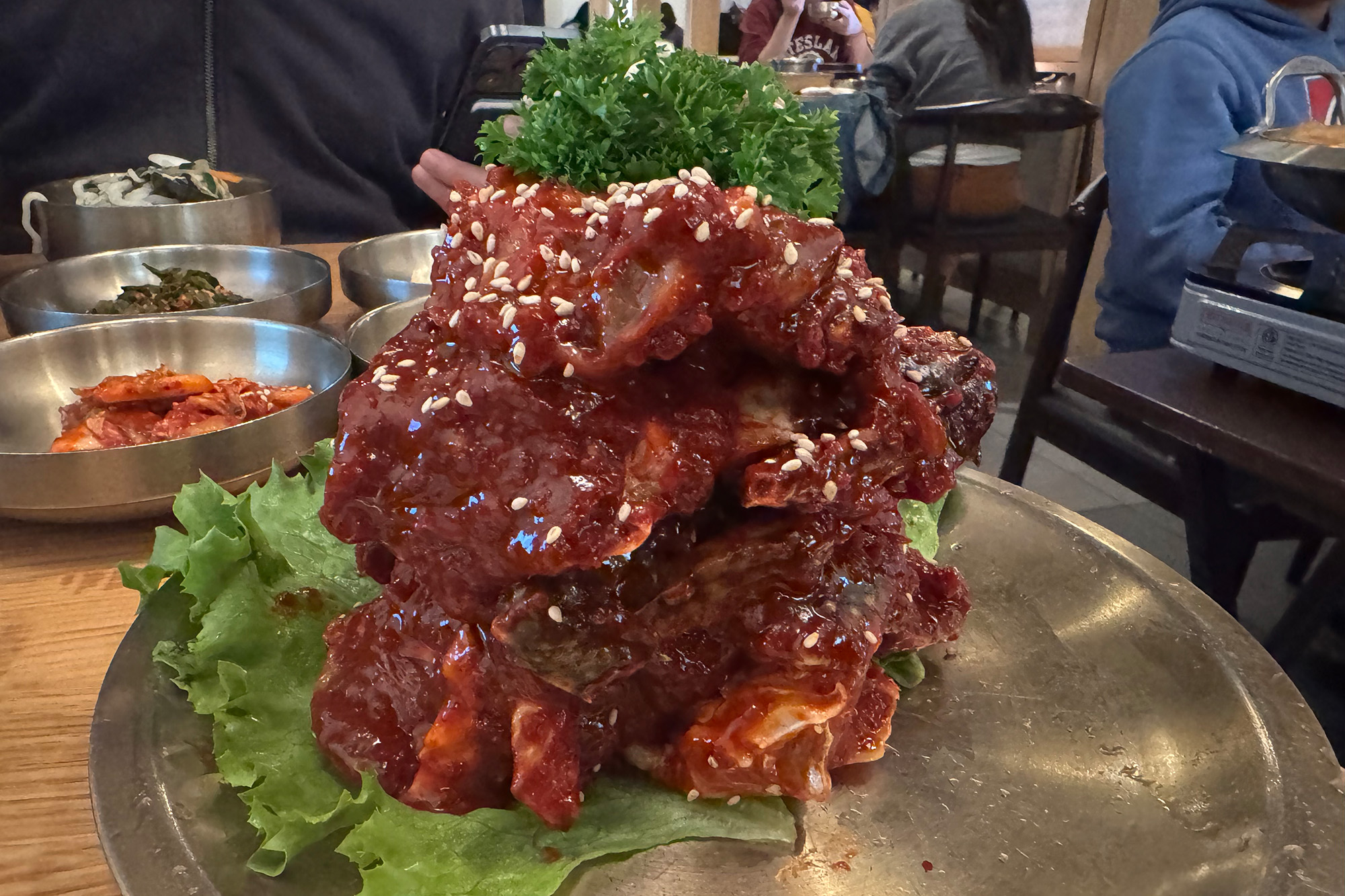 A stack of chili sauce covered raw blue crabs.
