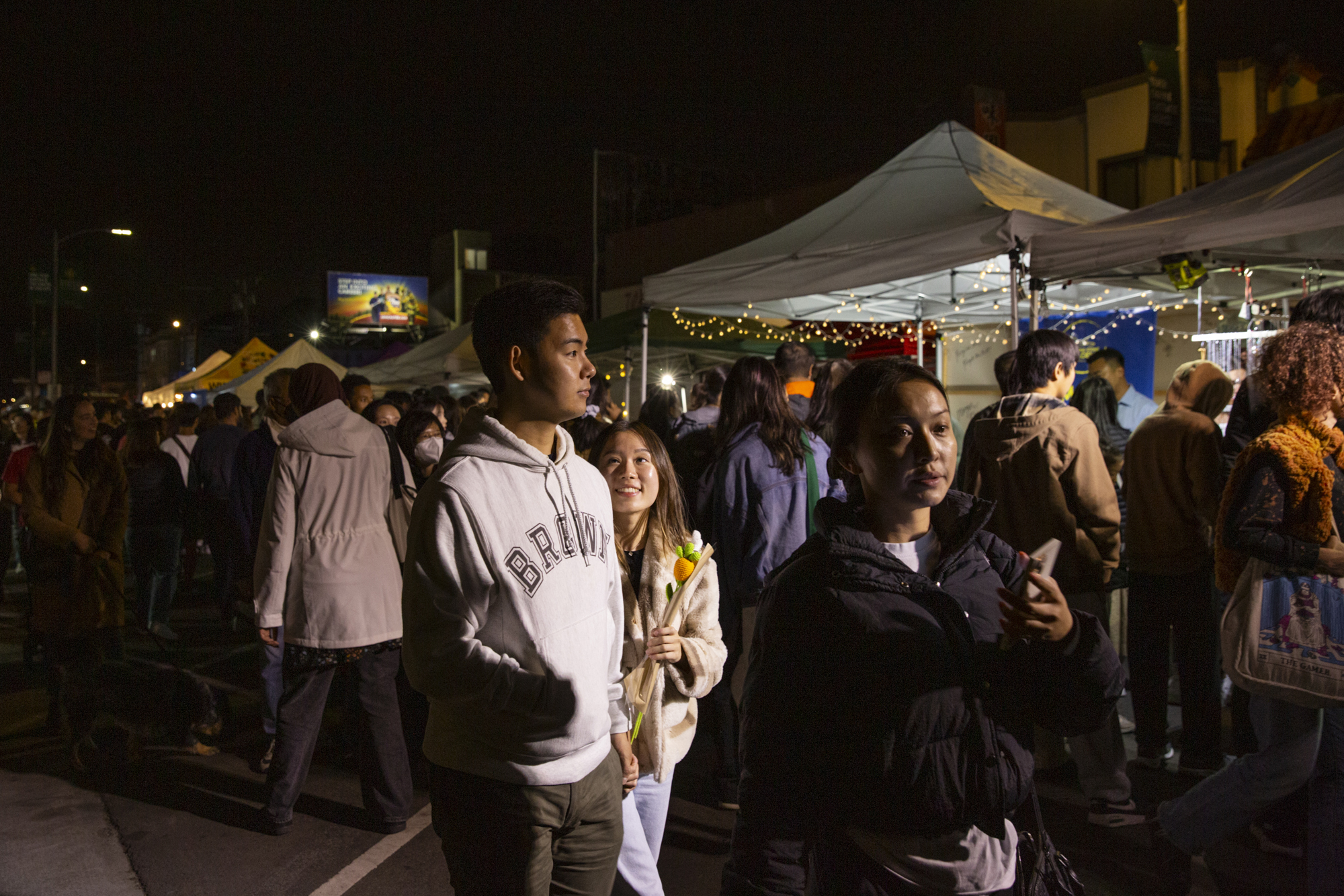 People strolling a crowded night market.