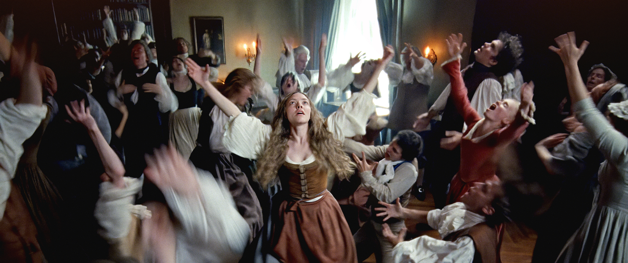 group of people in 18th-century clothes with arms extended in ecstatic dance