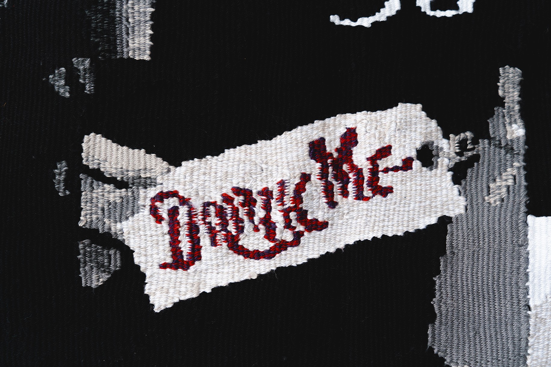textile in red, white, black and gray with text 'drink me'