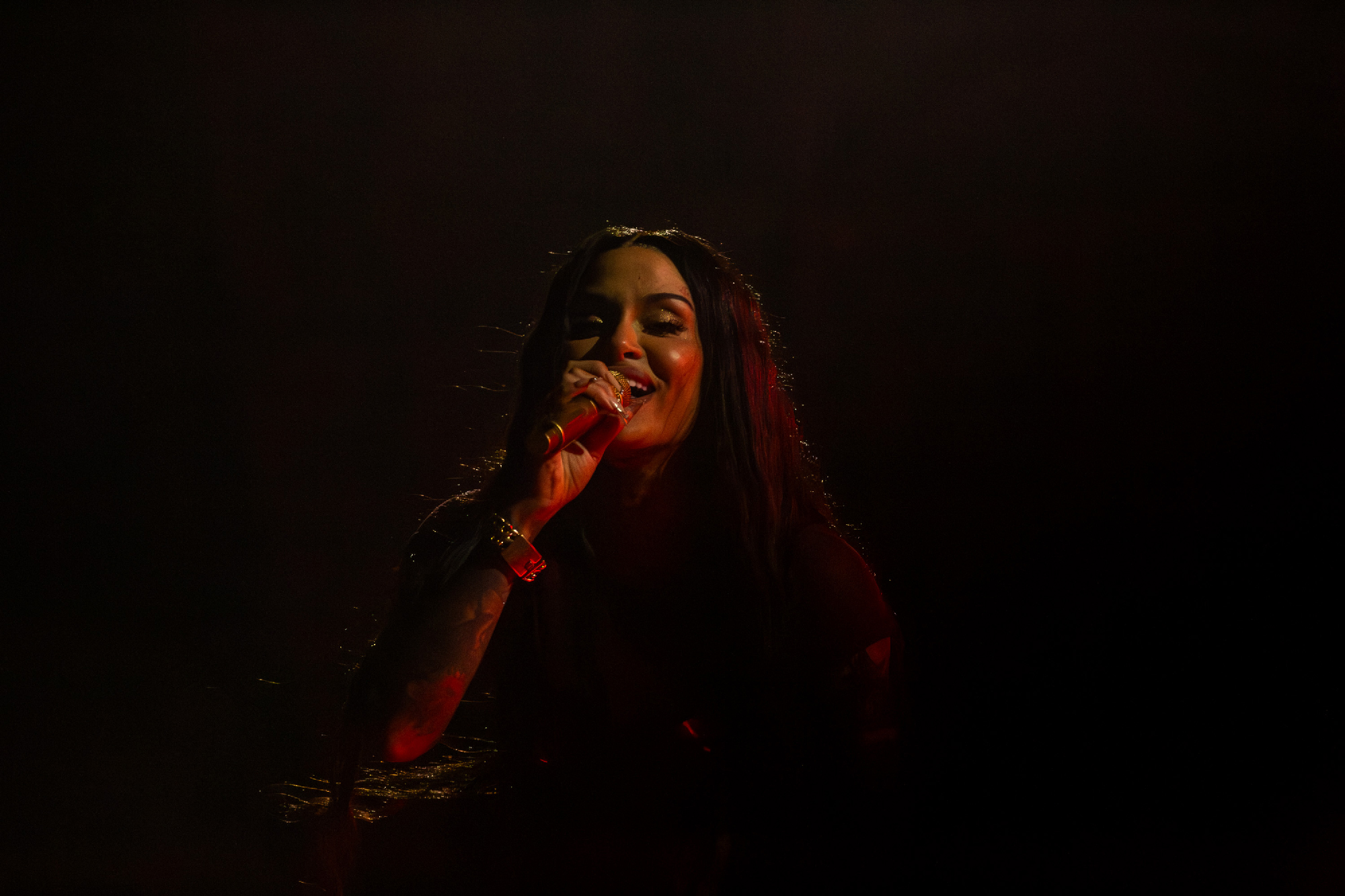 dimly lit performer with mic