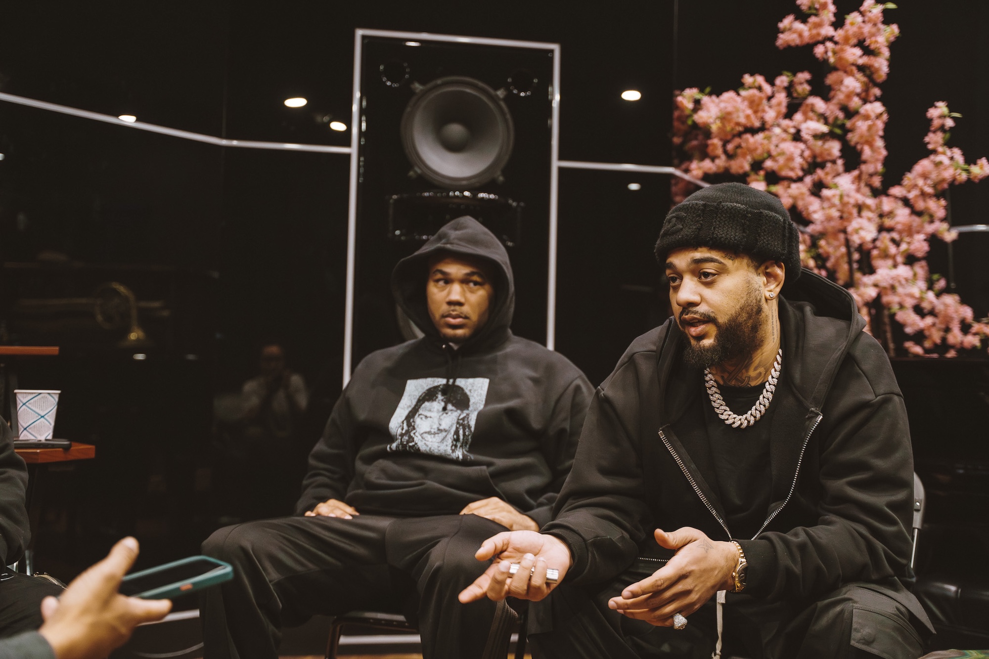 Two African-American men sit and talk in a studio in San Francisco. 