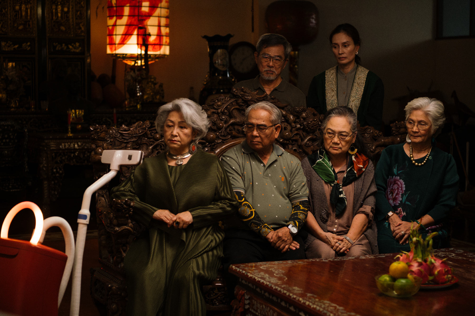 group of six older people face a vacuum cleaner