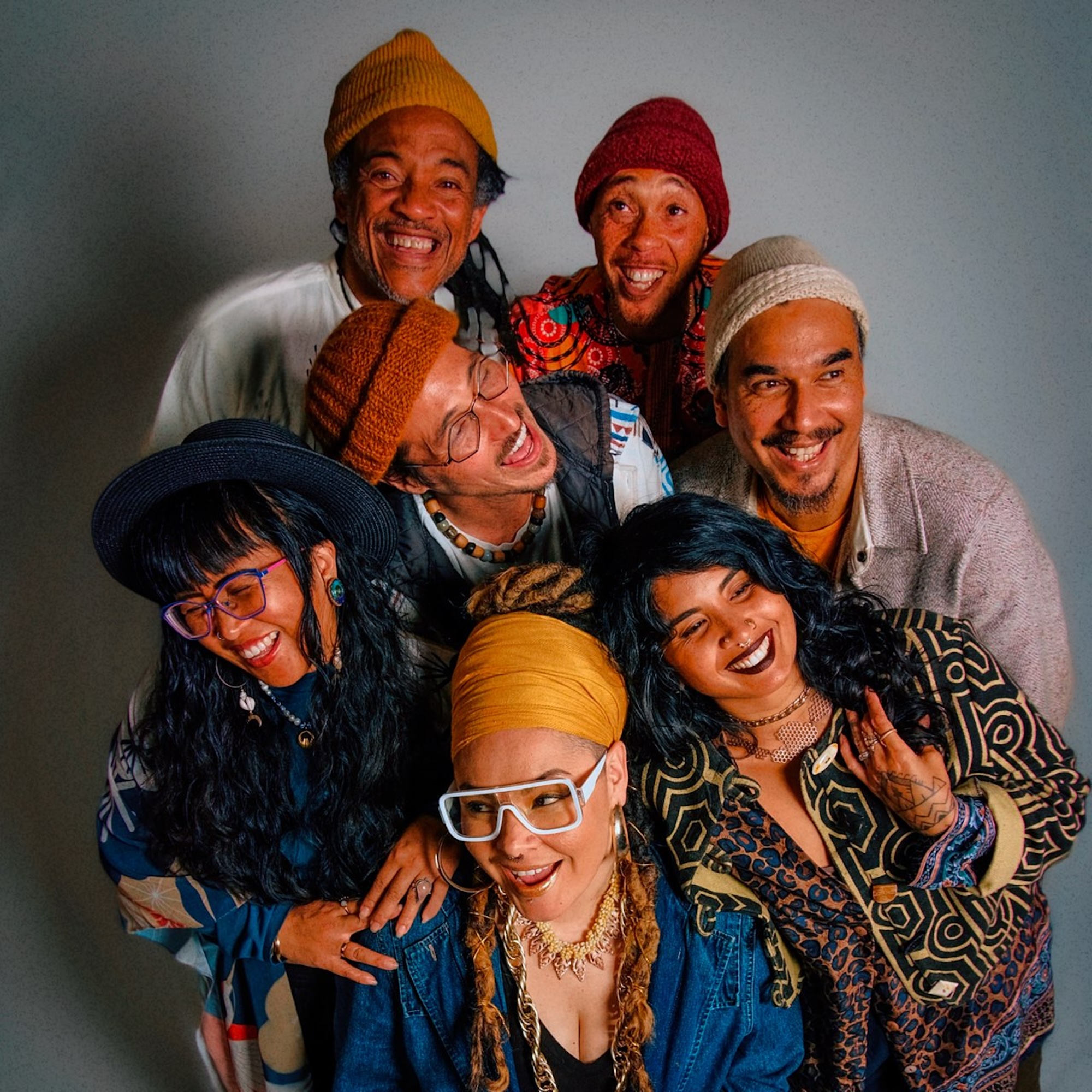 An overhead photo of seven people standing close together, almost hugging.